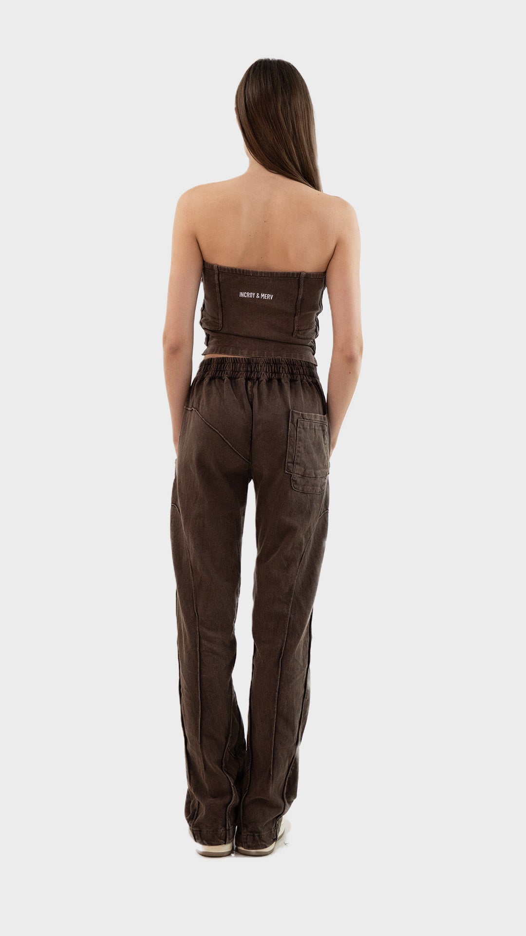 Full length back view of Incroy & Merv women's Beyond Co-Ord Set in washed brown ribbed fabric showing rear seam details and embroidery.