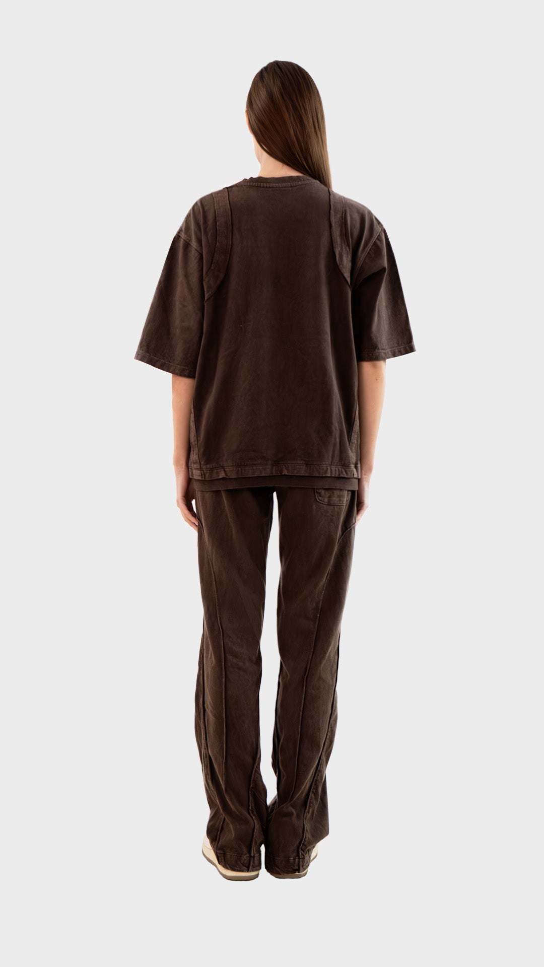 Full length back view of female model wearing Incroy & Merv women's brown Beyond Lower displaying rear seam construction.