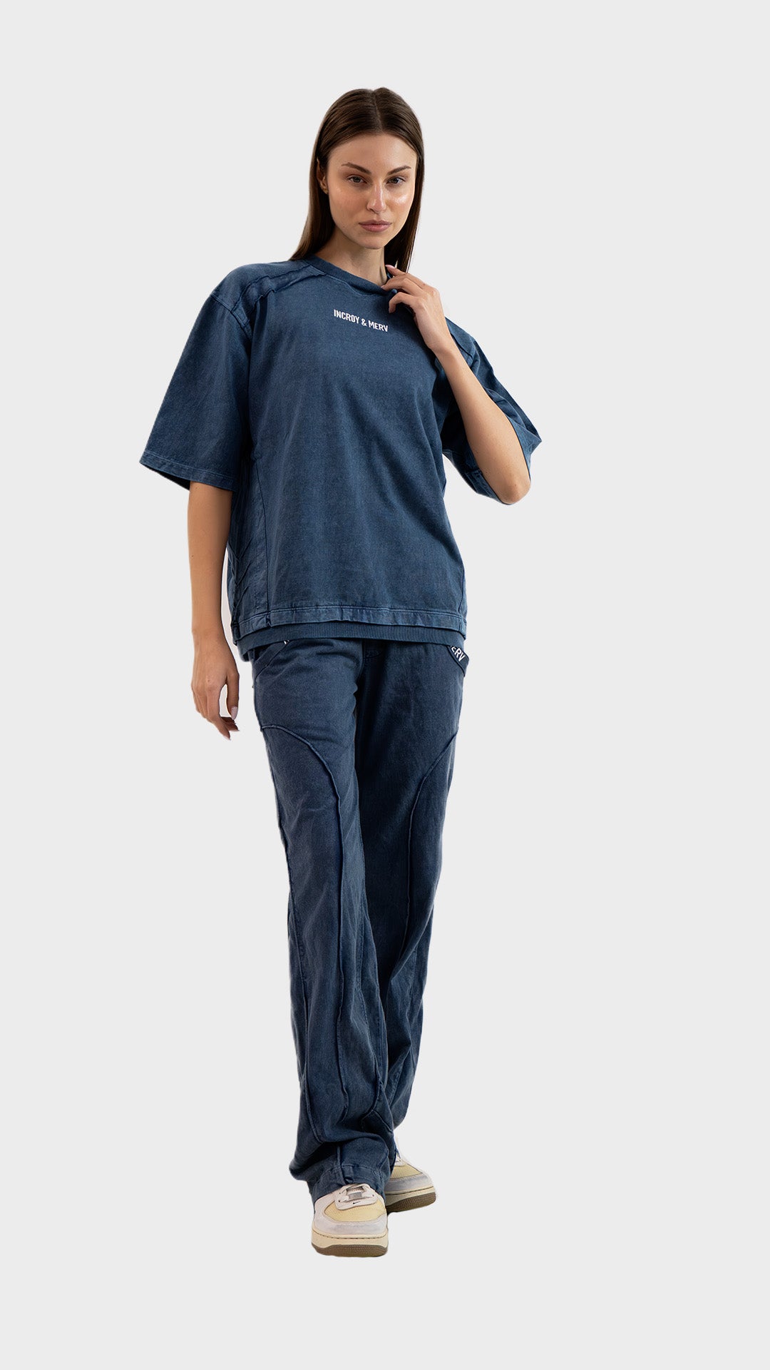 Three-quarter front view of Incroy & Merv women's Beyond Lower in dusky blue featuring panel stitching and pocket detail.