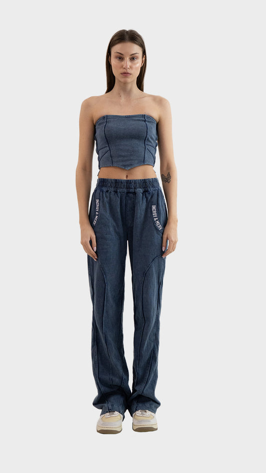 Full length front view of a model wearing Incroy & Merv women's dusky blue Beyond Trouser in cotton sinker fabric.