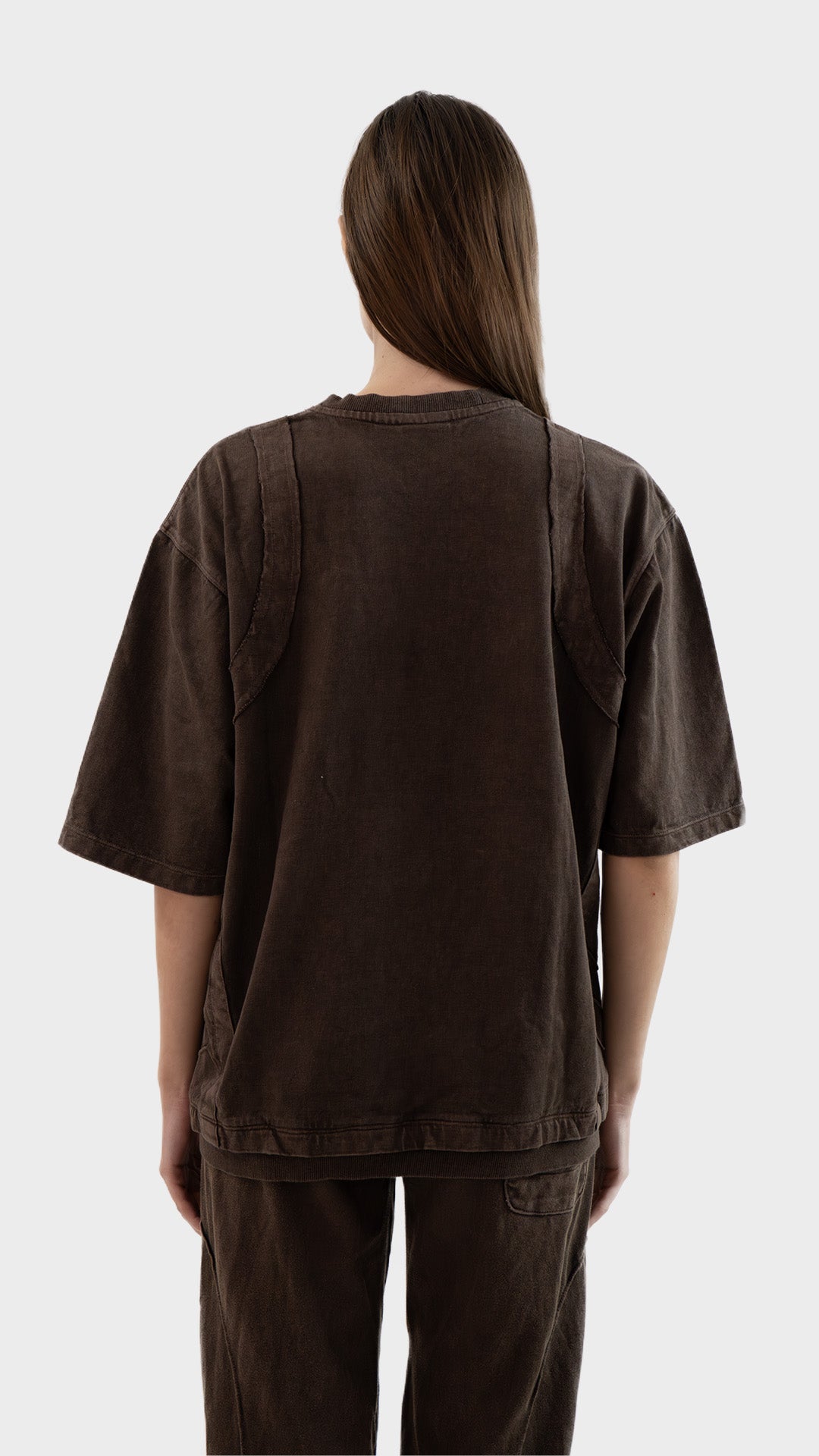 Back view of Incroy & Merv women's Beyond T-Shirt in brown showing relaxed oversized fit and seam detailing.