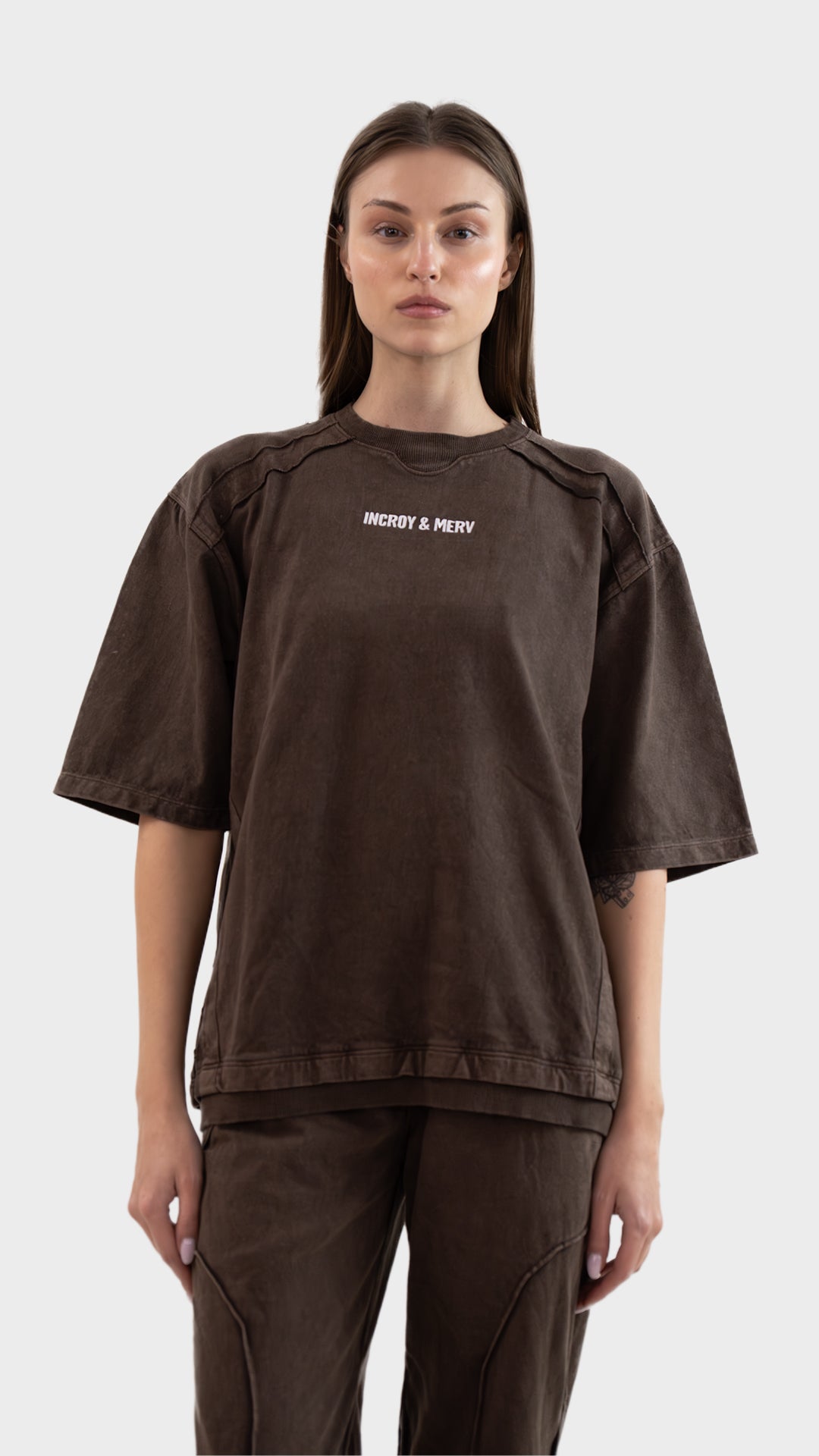 Front view of Incroy & Merv women's Beyond T-Shirt in washed brown cotton sinker fabric with embroidered logo detail.