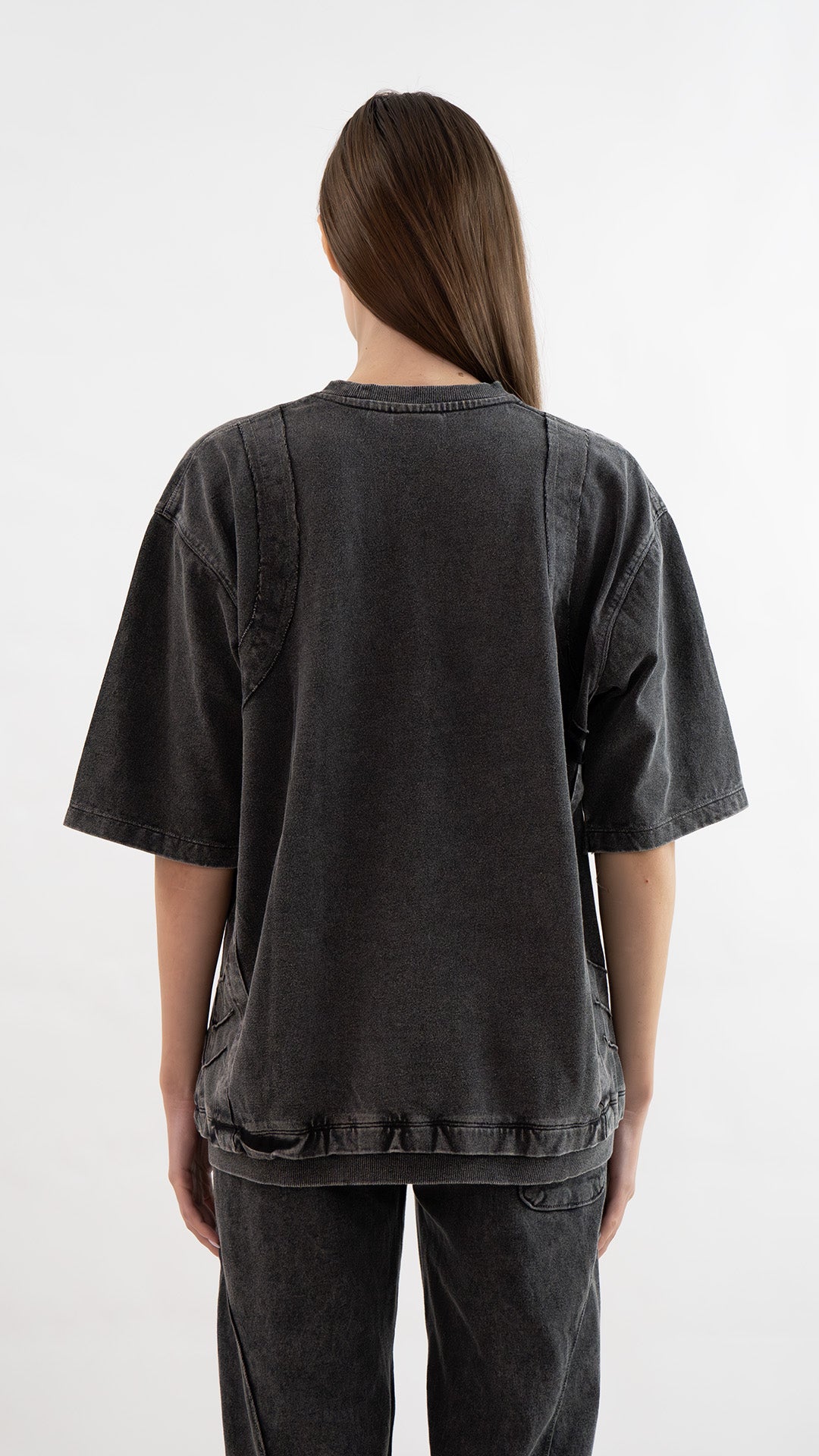 Back view of Incroy & Merv women's Beyond T-Shirt in charcoal showing relaxed oversized fit and seam detailing.