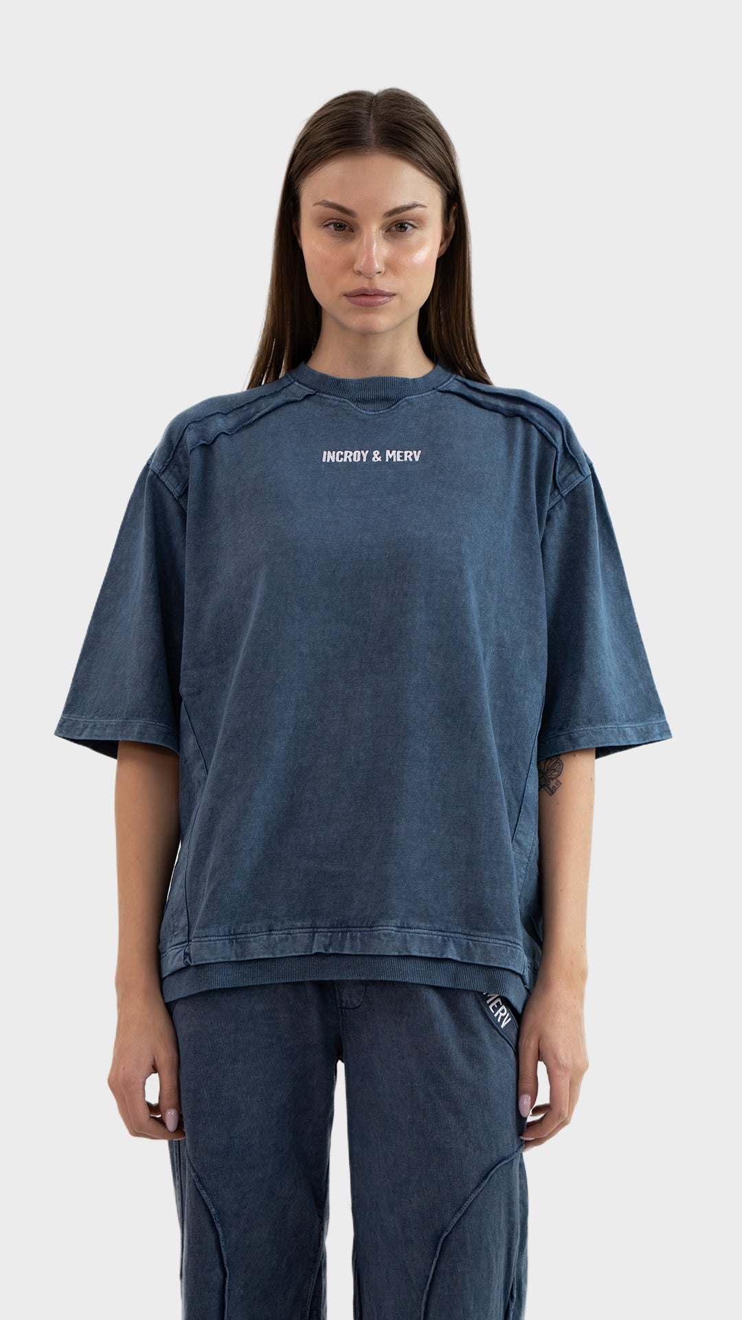 Front view of Incroy & Merv women's Beyond T-Shirt in dusky blue soft cotton sinker fabric with embroidered logo detail.