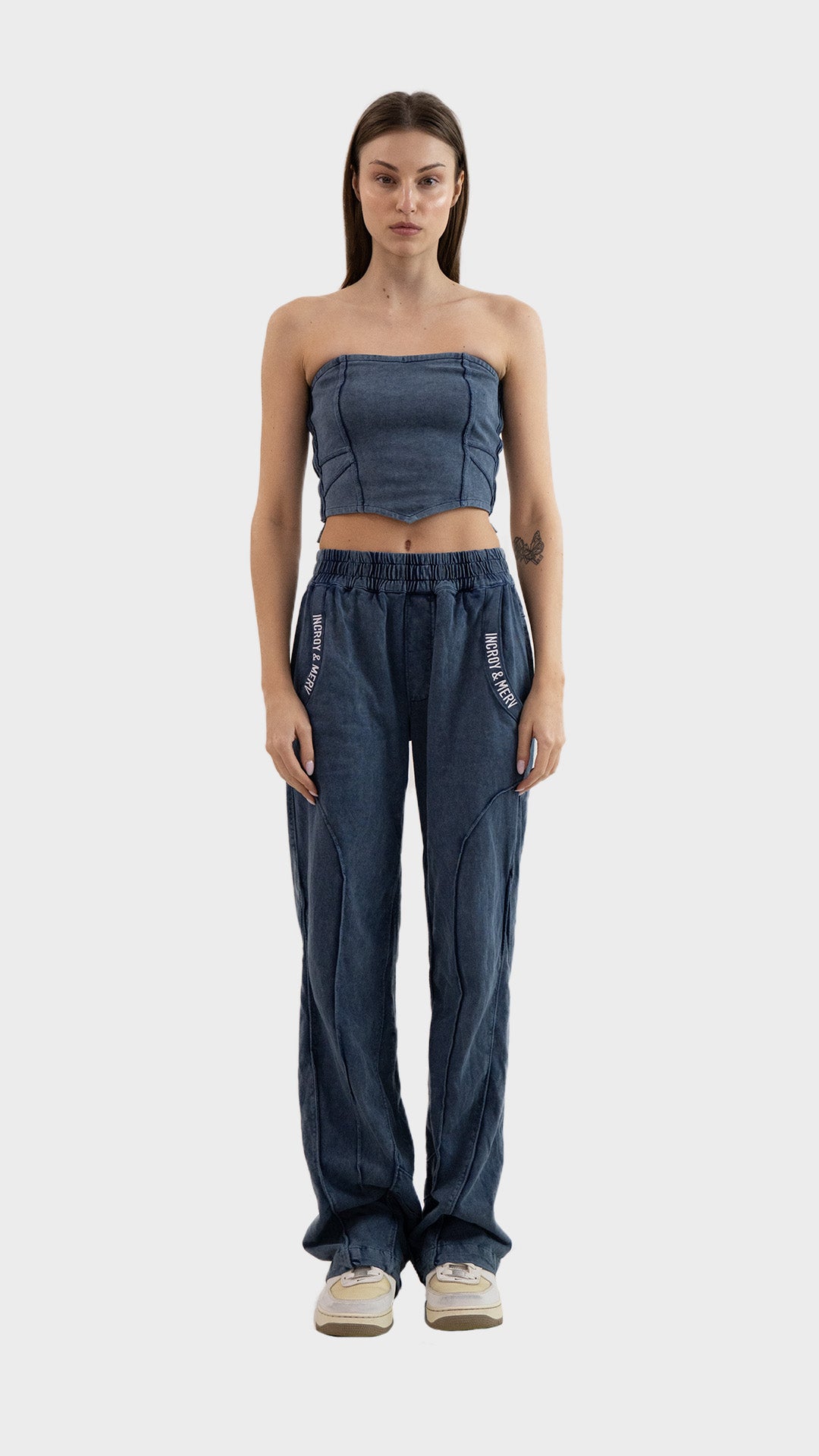 Full body view of model wearing the Incroy & Merv Beyond Tube Top styled with matching dusky blue track pants.
