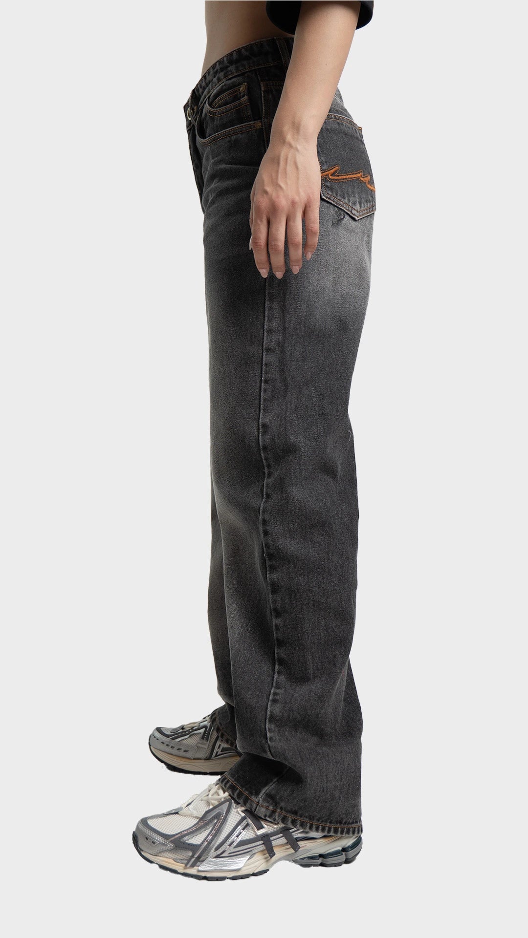Side angle profile of Incroy & Merv women's loose fit smoked grey jeans.