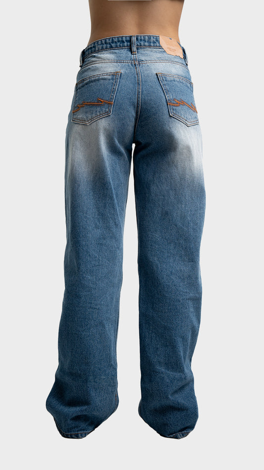 Back pockets and fit perspective of Incroy & Merv women's relaxed fit streetwear jeans in nitro blue.