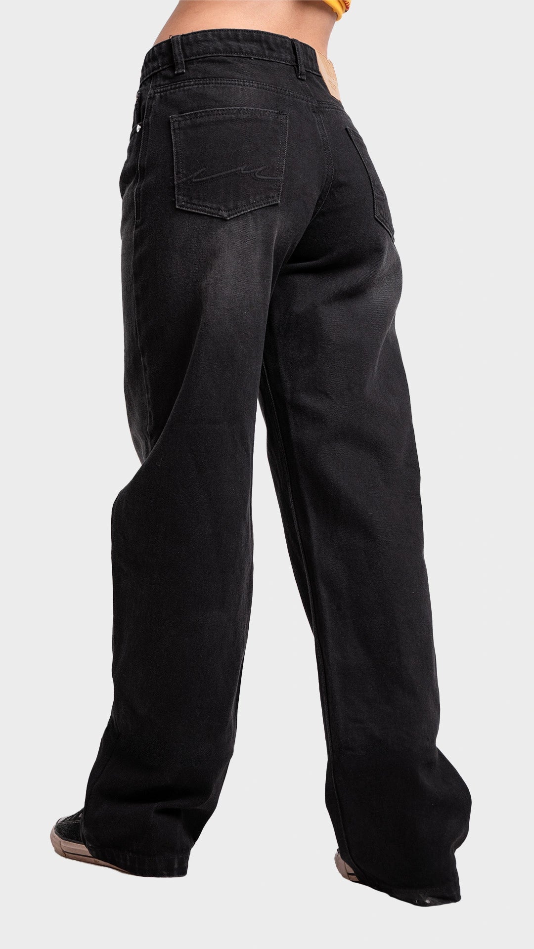 Three-quarter back angle view of women's wide leg drift black denim jeans by Incroy & Merv.