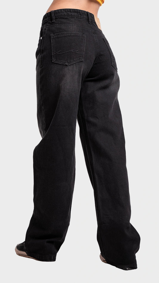 Three-quarter back angle view of women's wide leg drift black denim jeans by Incroy & Merv.