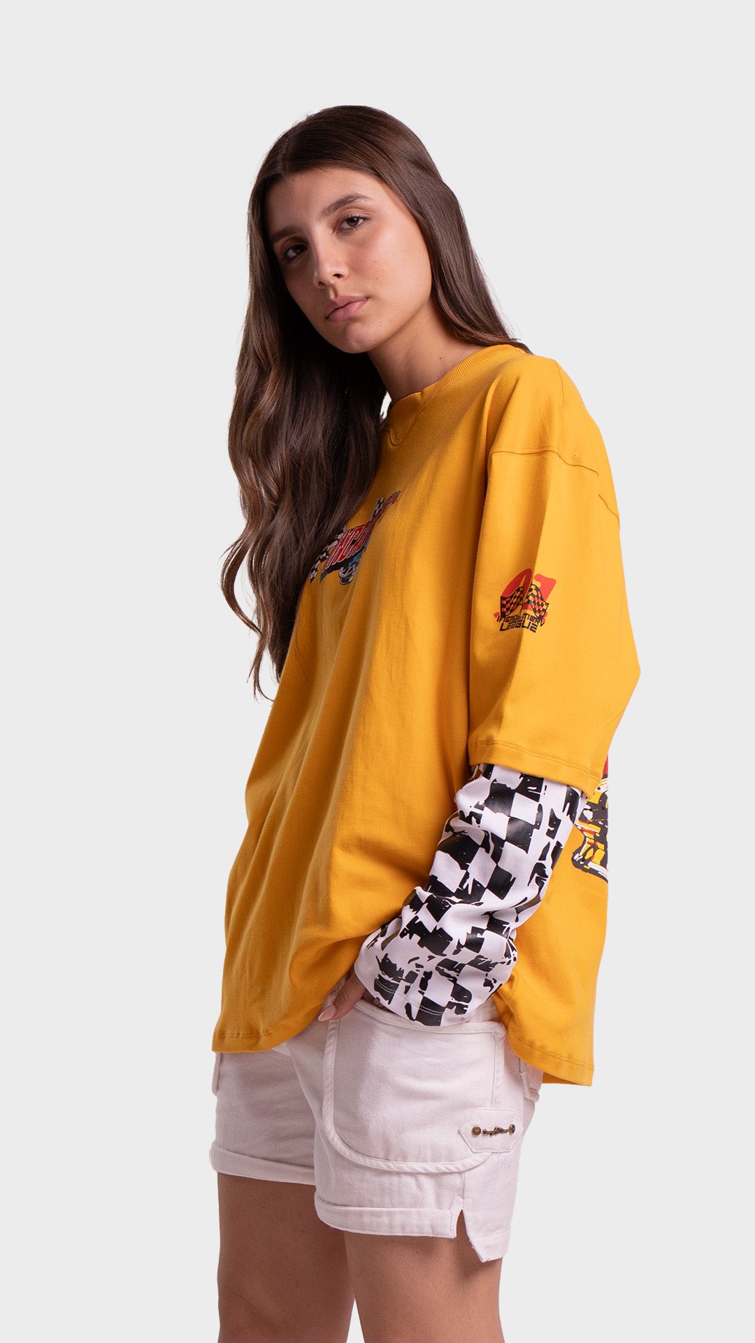 Side view of Incroy & Merv yellow oversized racing graphic tee showing streetwear styling.