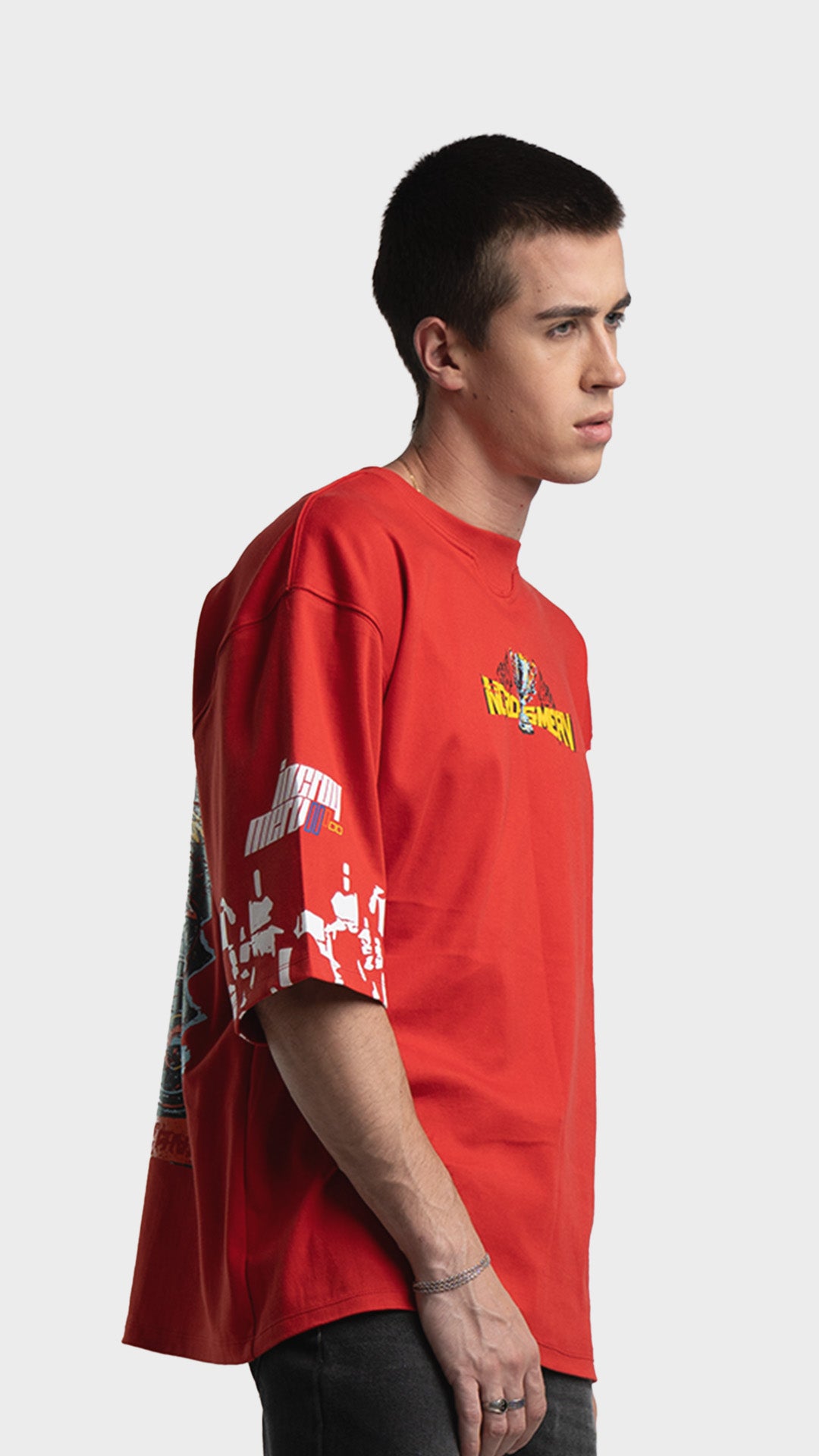 Mediumweight red streetwear t-shirt. Drop-shoulder oversized graphic tee showing checkered graphic prints on the sleeves.