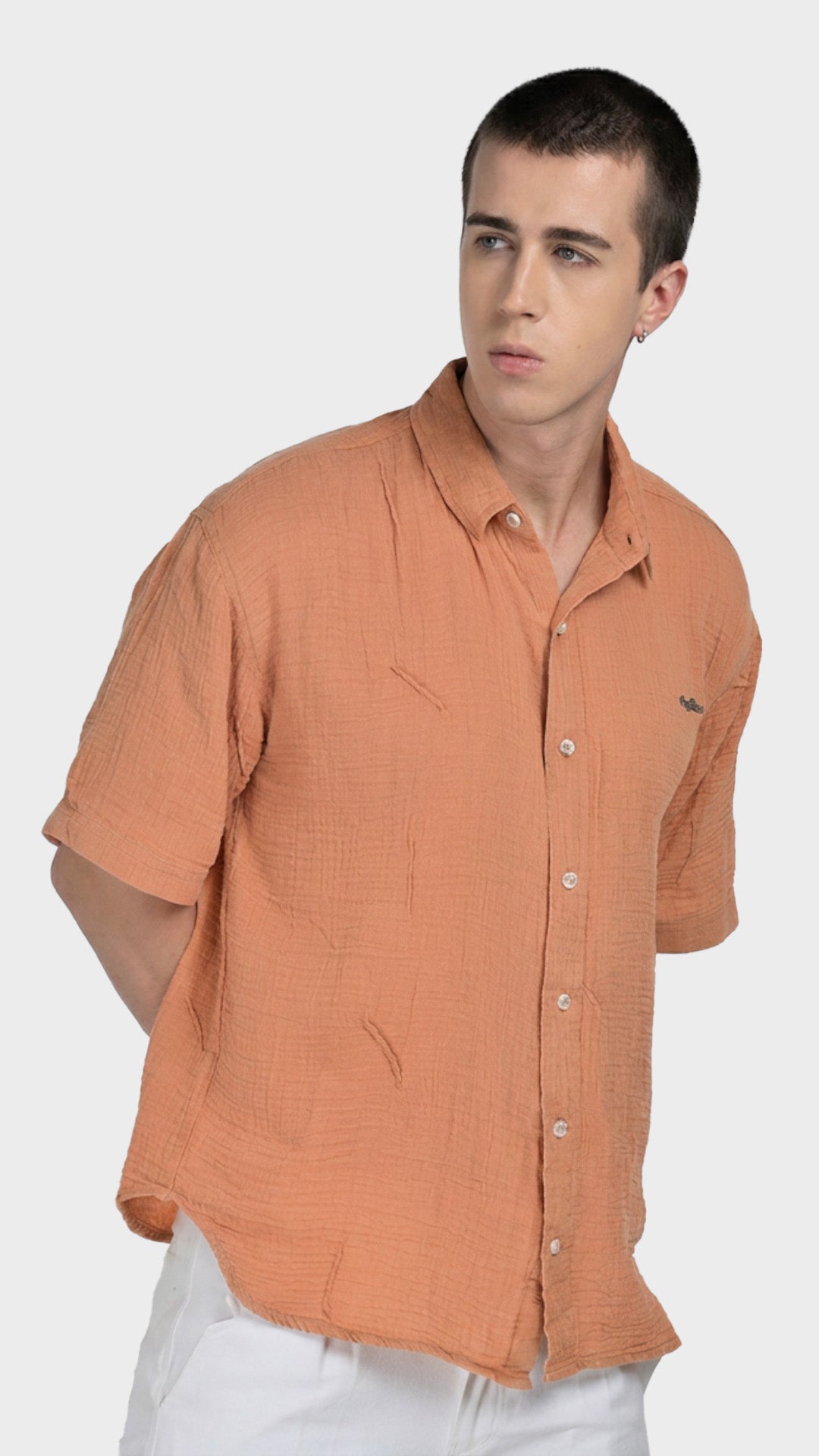 Front profile of a male model wearing a peach double cloth cotton casual shirt.