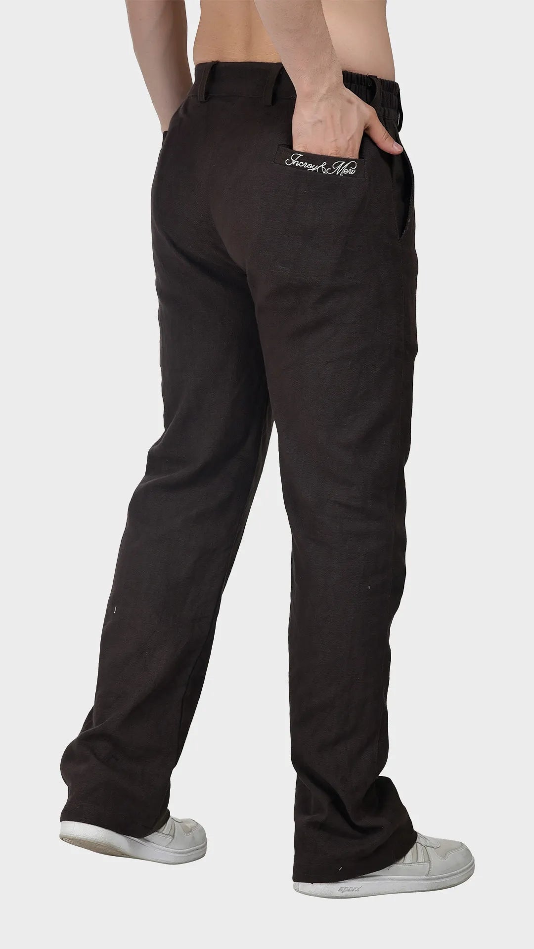 Back three-quarter view showing the embroidered back pocket on brown slub pants.