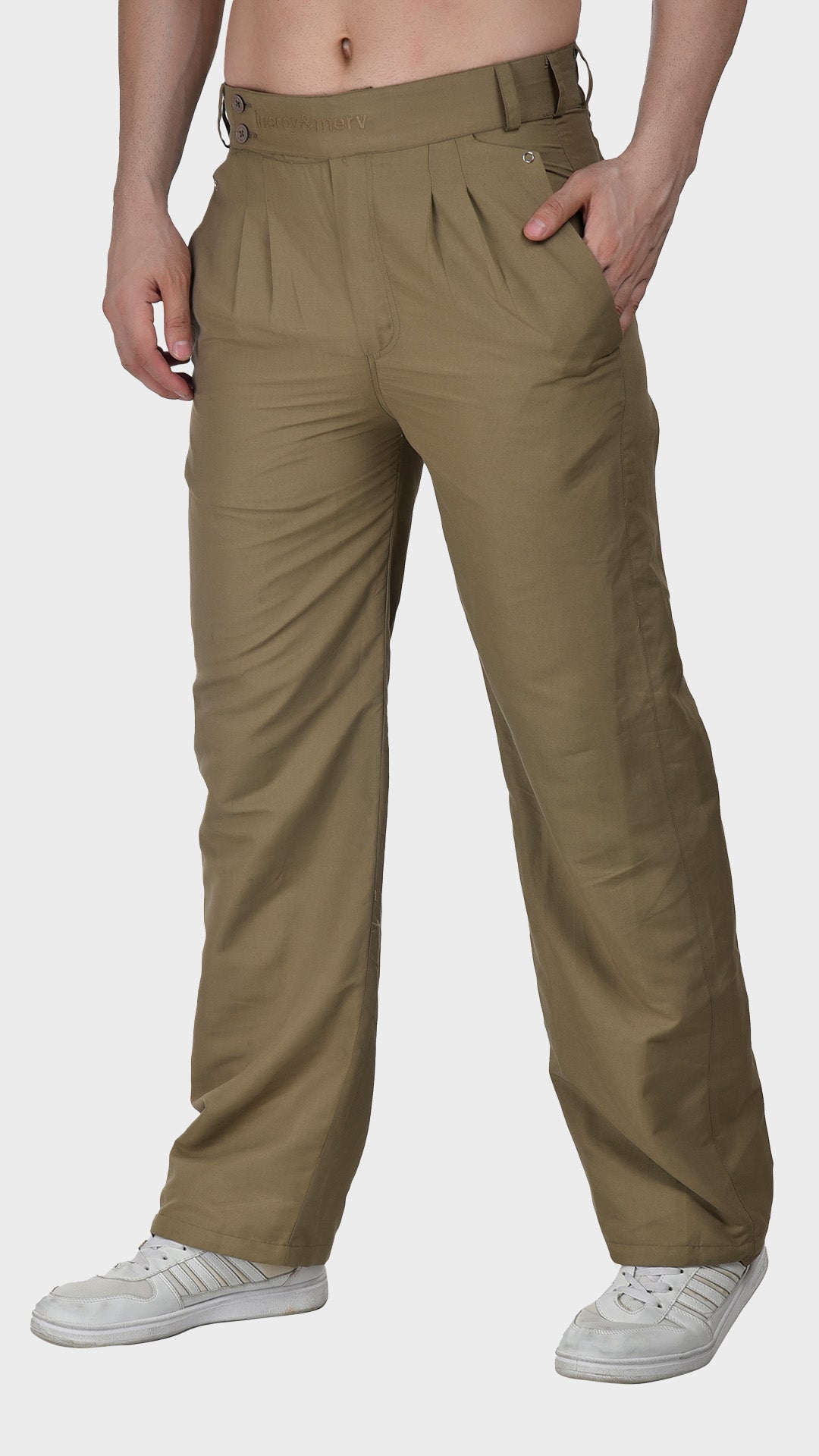 Three-quarter front view of men's khaki pleated cotton Oxford trousers styled with white sneakers for a smart-casual look.