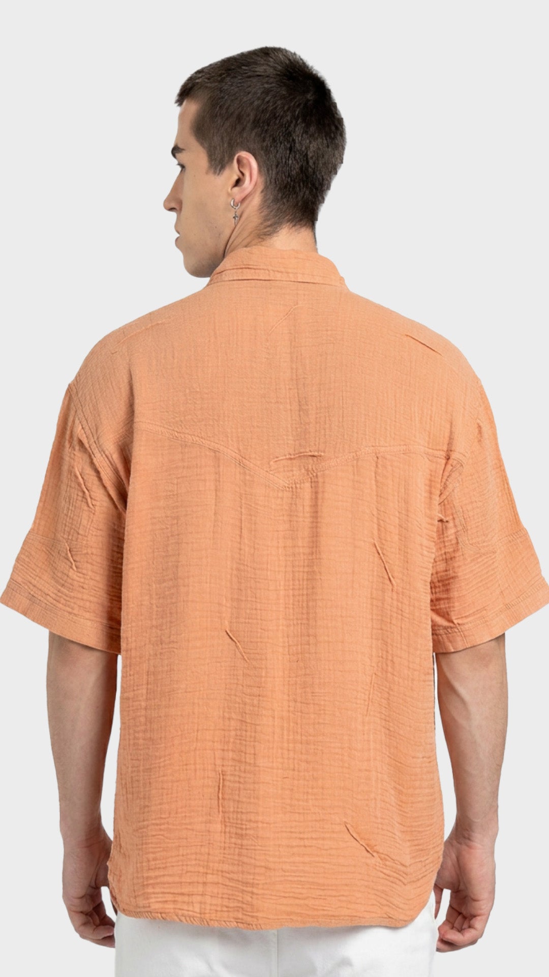 Direct back view of a men's peach short sleeve 100% cotton double cloth shirt.
