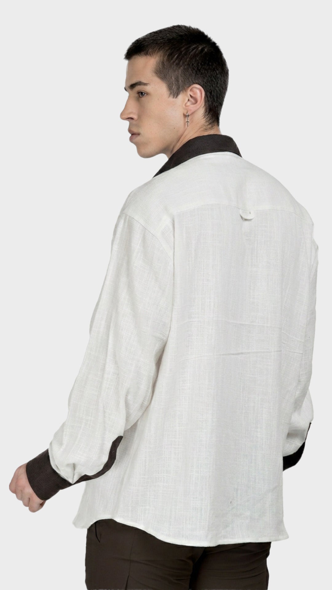 Side back view showing brown contrast cuffs on a men's white slub fabric shirt.
