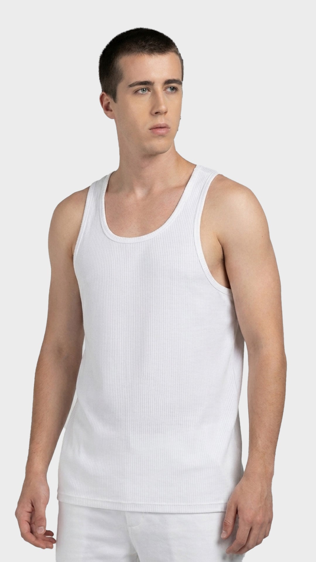 Three-quarter angle view of a male model wearing a white parker fabric vest.