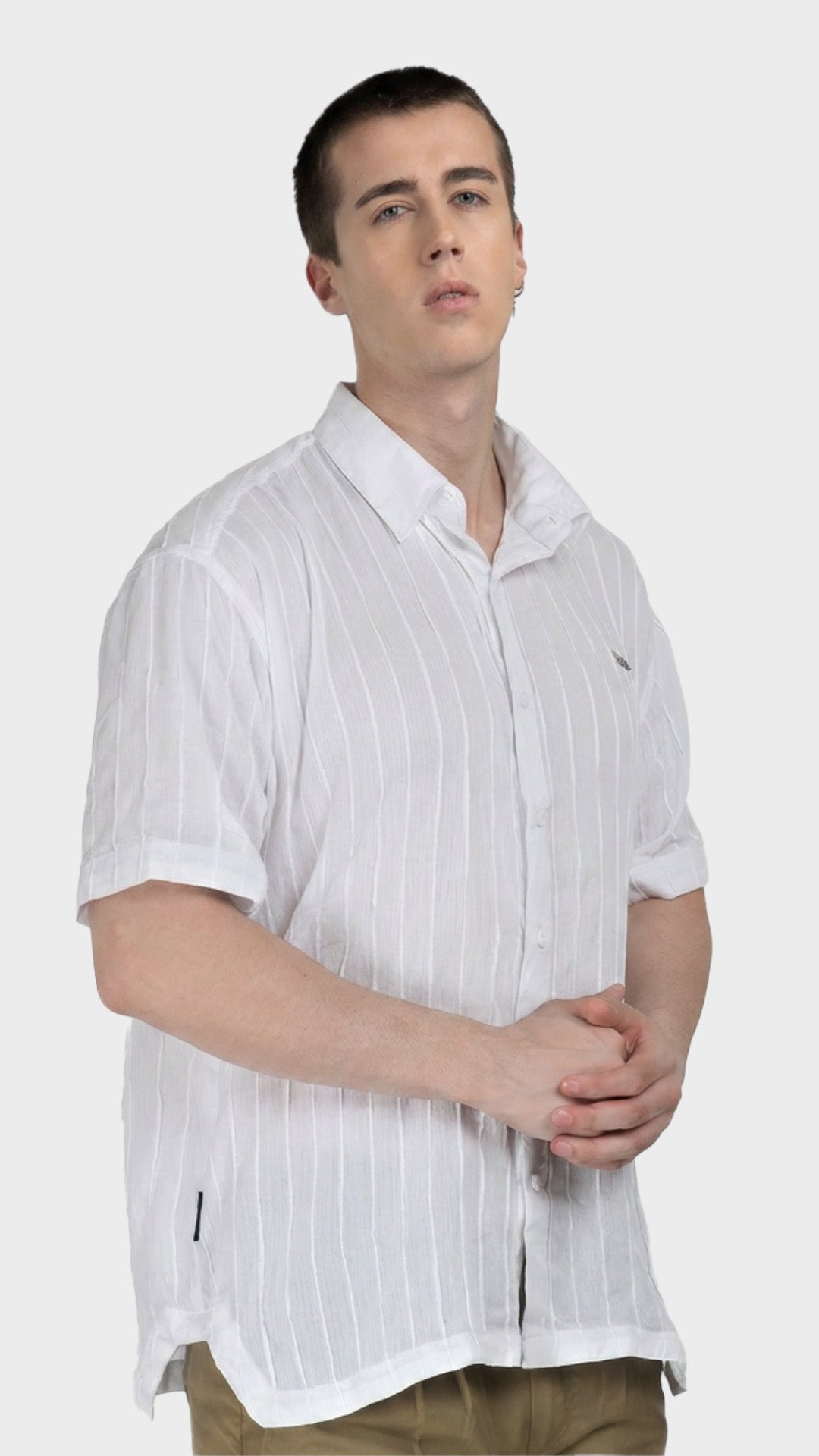 Three-quarter view of a men's white short sleeve rayon crepe shirt.
