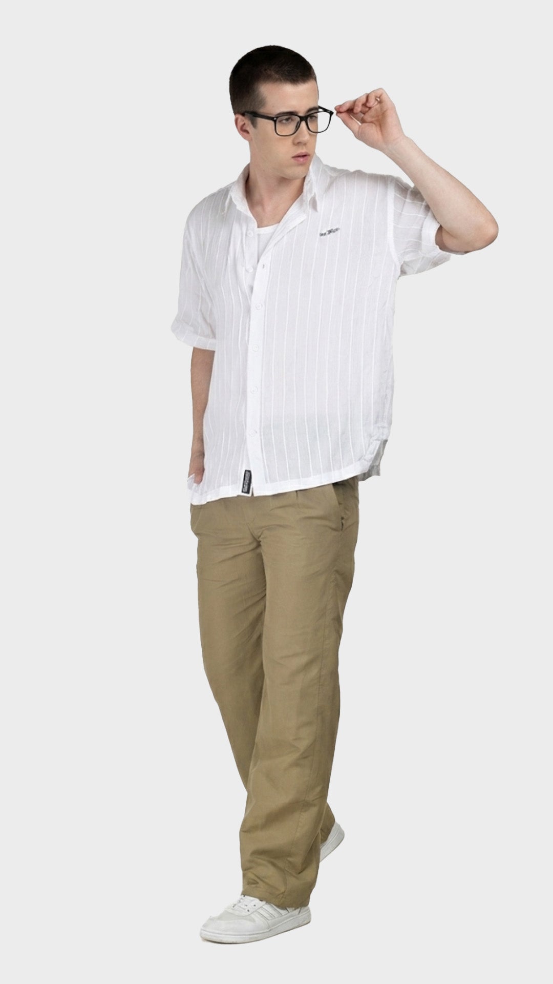 Full-body shot of a male model wearing a white short sleeve rayon crepe shirt and glasses.