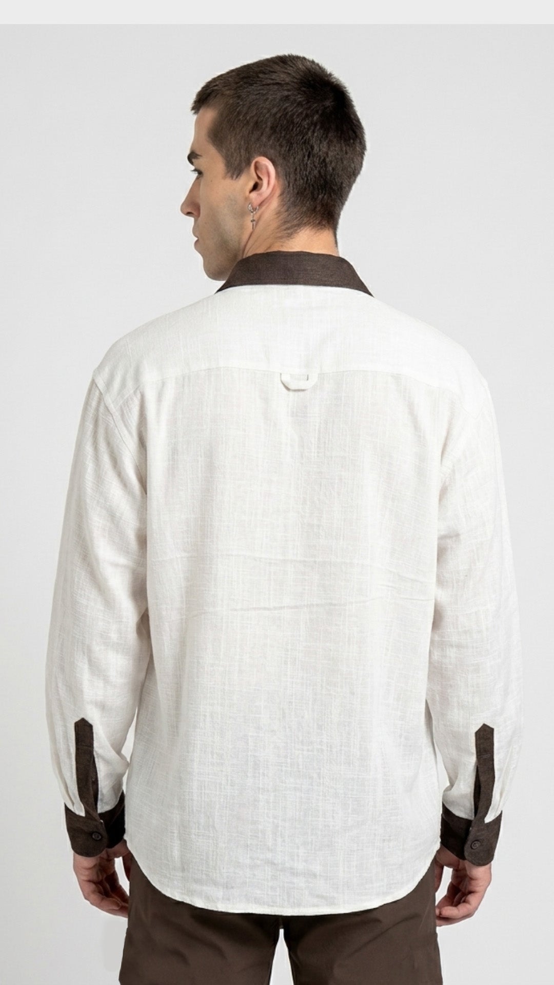 Direct back view of a men's long sleeve white slub fabric shirt.