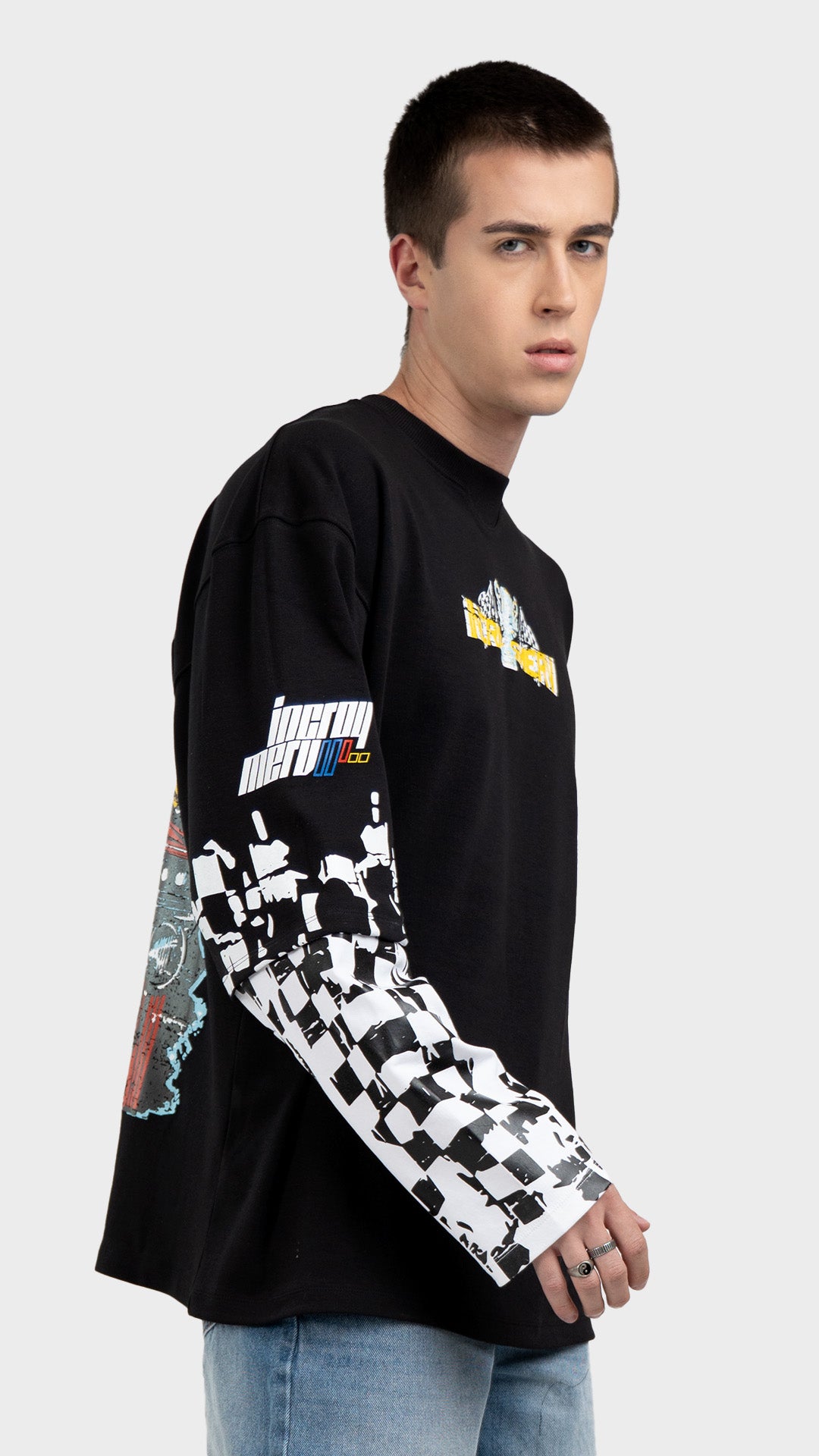 Mens black layered graphic tee side view. Incroy & Merv breathable, lightweight feel long sleeve streetwear shirt styled with light blue jeans.