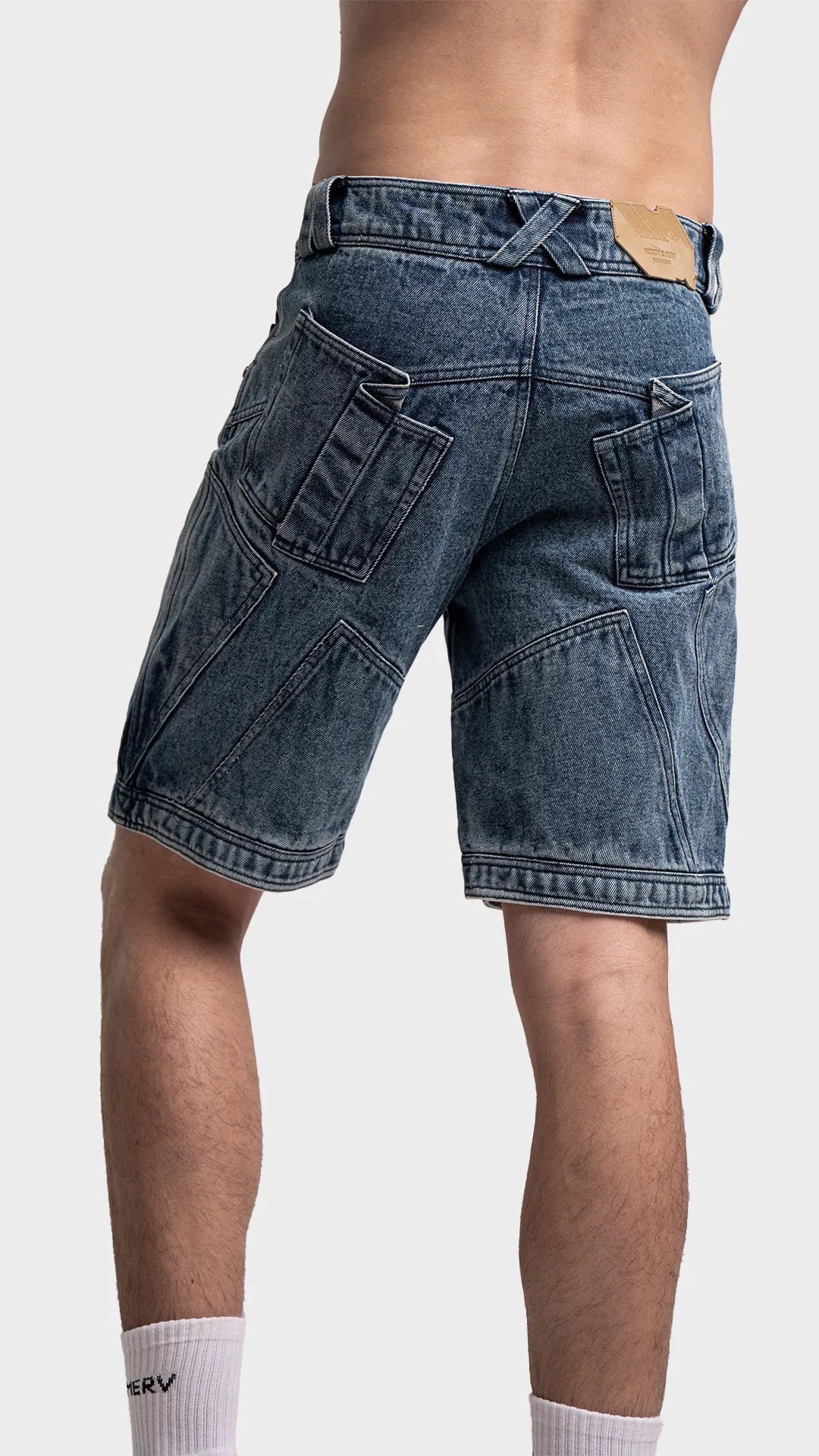 Back view of men's blue acid wash jean shorts showing pockets and fit.
