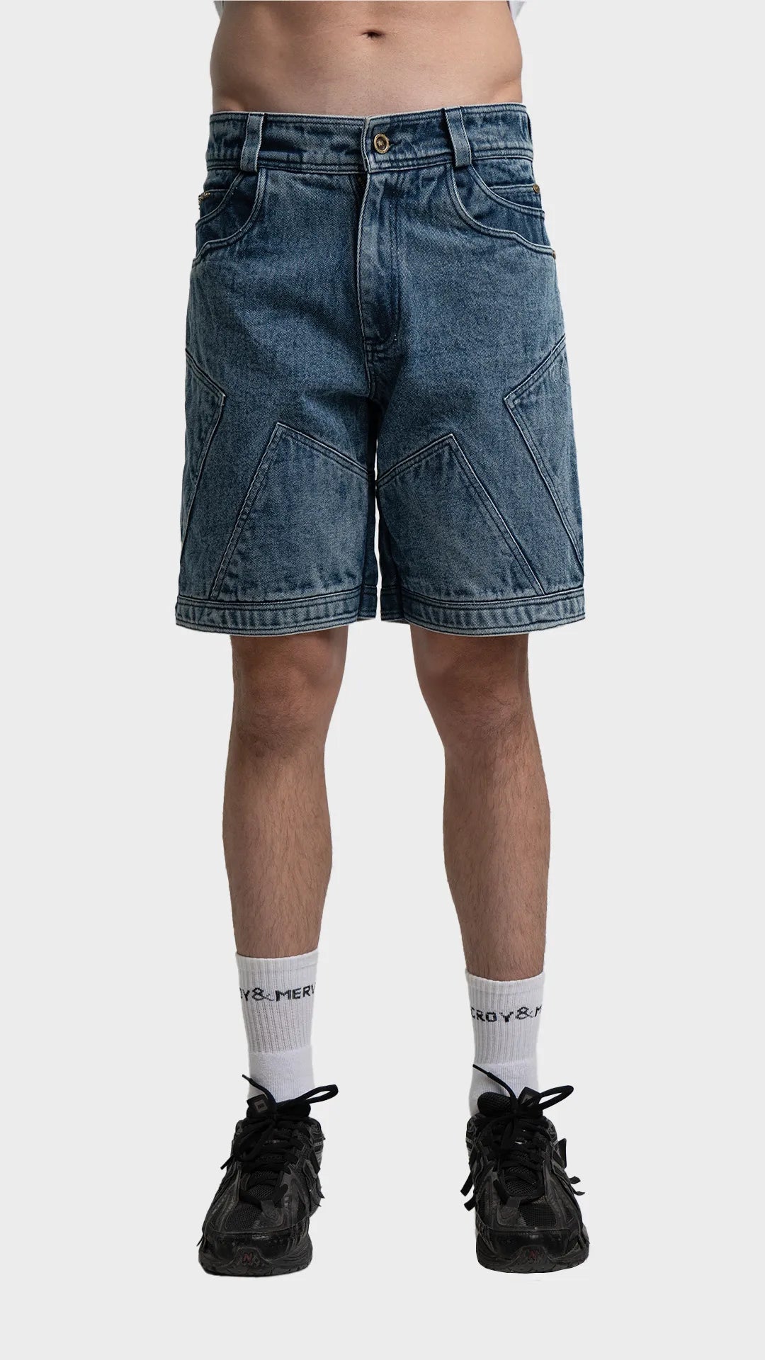 Front view of men's blue acid wash denim shorts with geometric panel stitching.