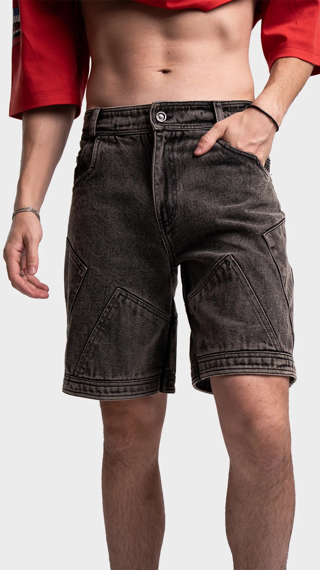 Front view of men's dark grey acid wash denim shorts with panel details.