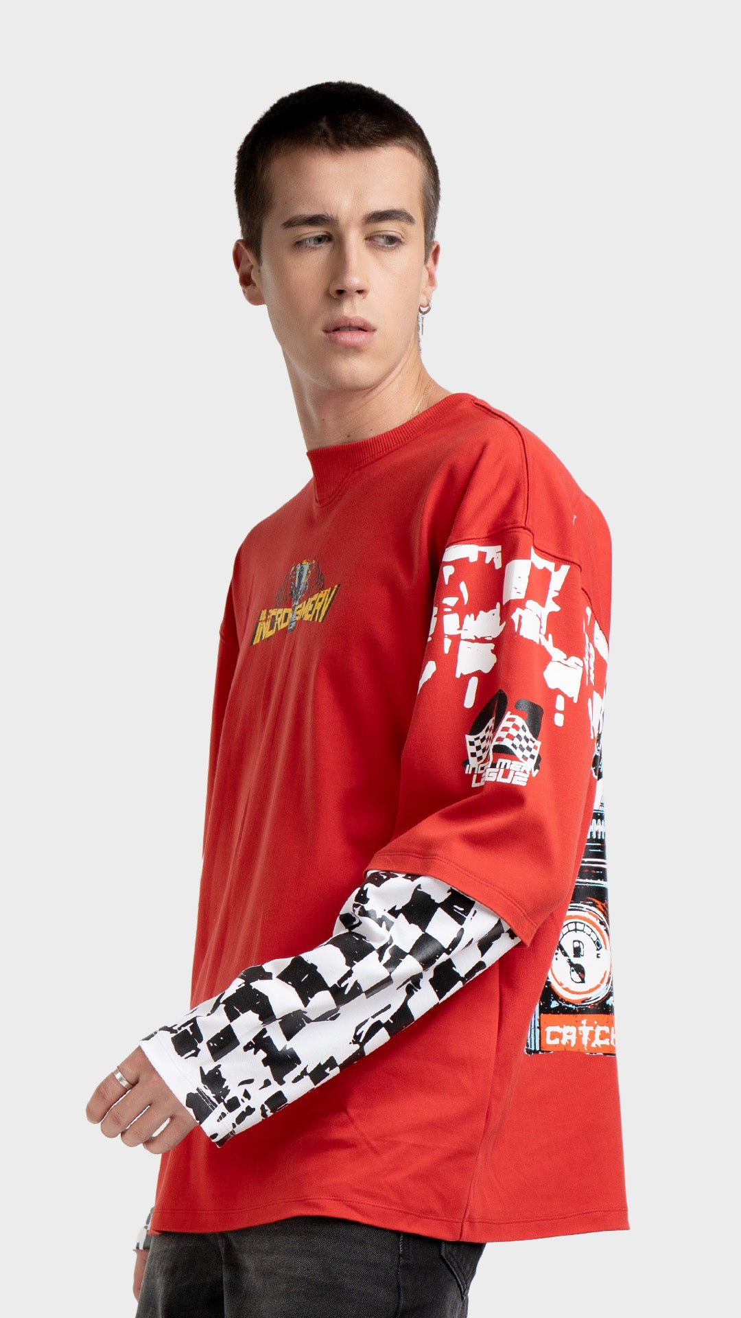 Mens red layered graphic tee side view. Incroy & Merv breathable, lightweight feel long sleeve streetwear shirt styled with dark wash jeans.