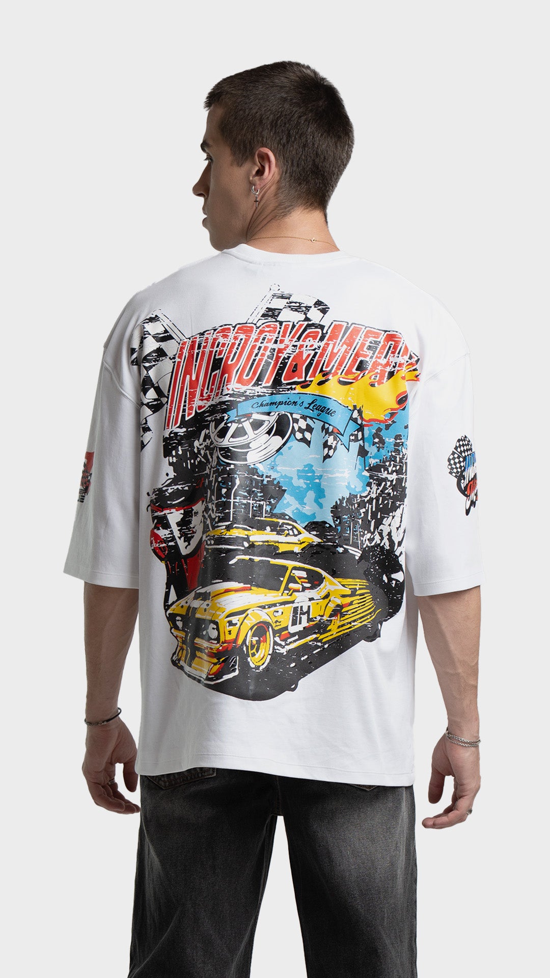 Large vintage race car graphic print on the back of a white oversized streetwear t-shirt.