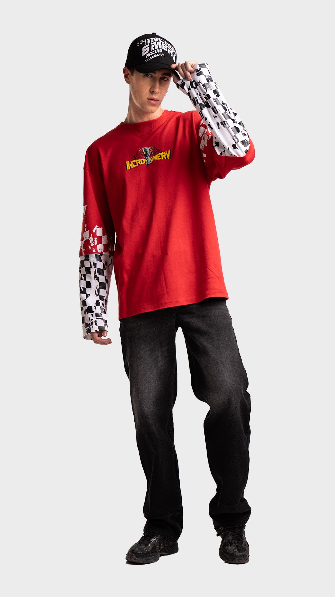 Red double sleeve racing tee outfit. Incroy & Merv oversized long sleeve summer streetwear shirt styled with a black graphic cap and dark loose jeans.