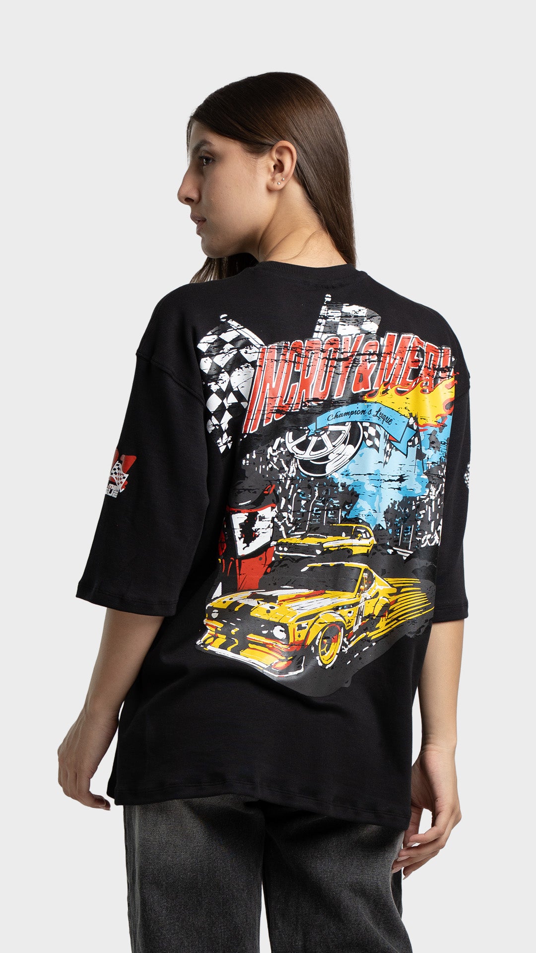 Back view of a black t-shirt featuring a large yellow vintage racing car graphic.
