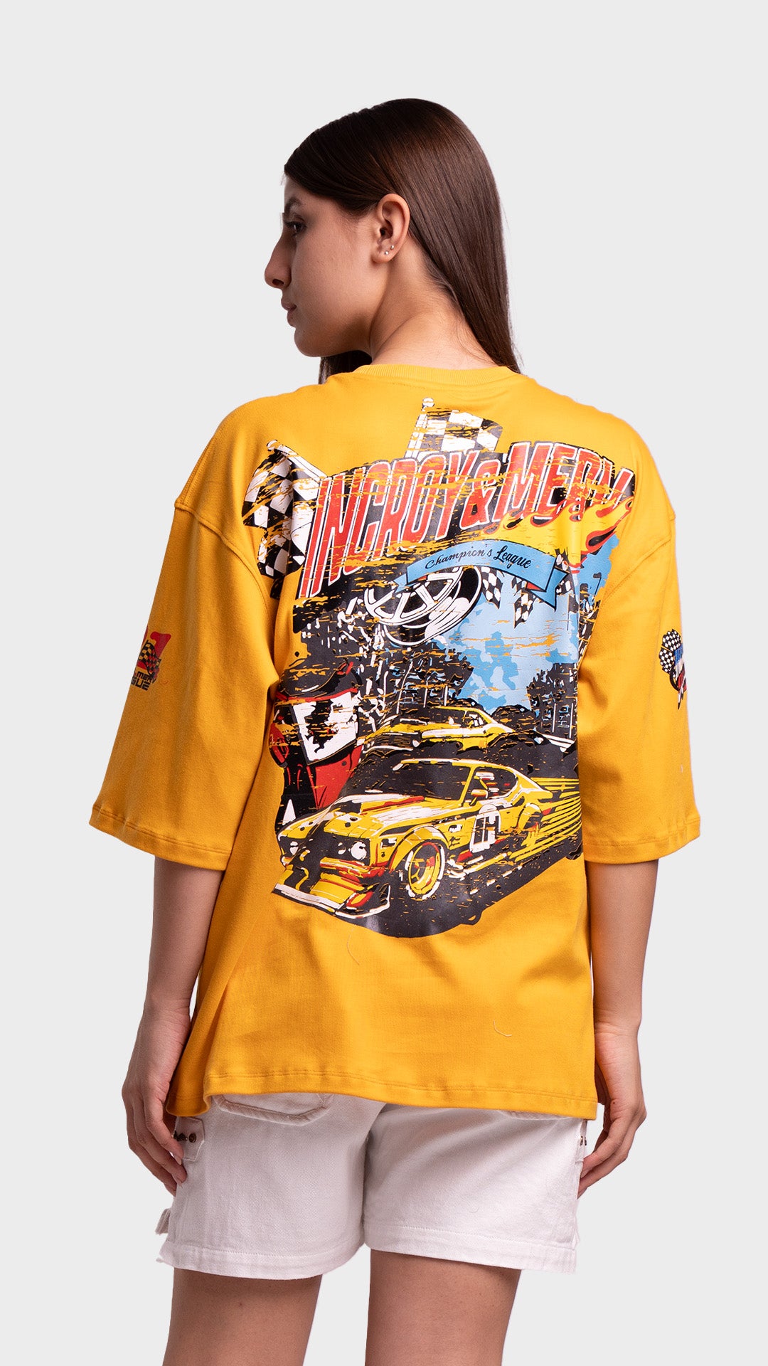 Back view of a mustard yellow t-shirt featuring a large yellow vintage racing car graphic