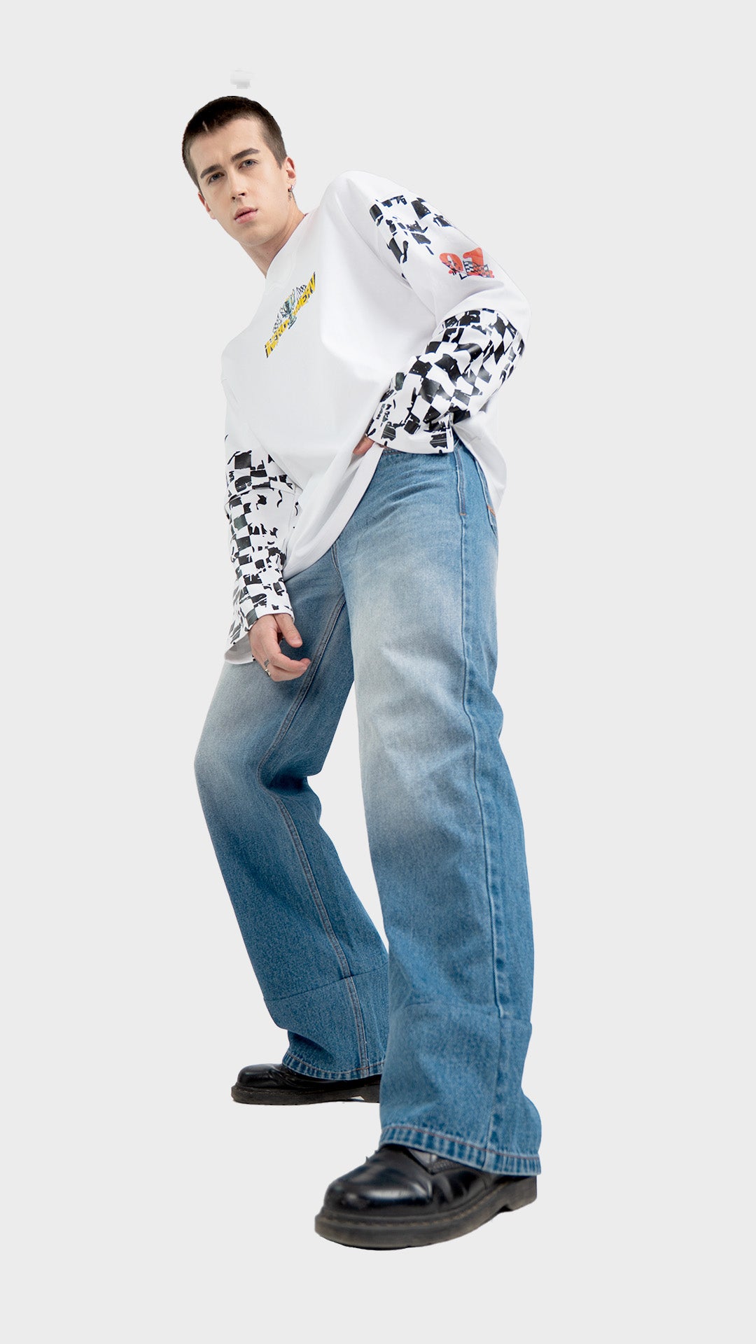 White double sleeve racing tee outfit. Low angle dynamic shot of Incroy & Merv oversized long sleeve summer streetwear top with loose light wash jeans.