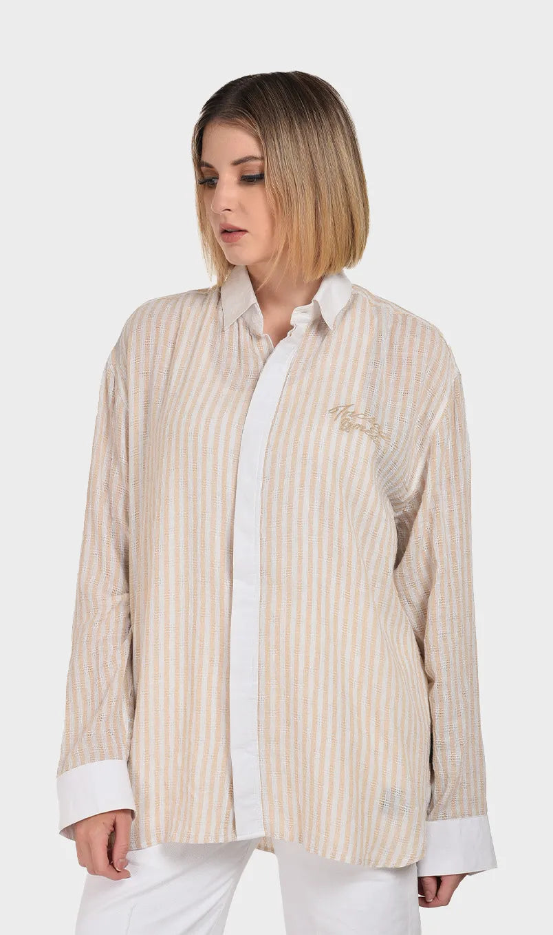 Front view of a women's beige and white striped long-sleeve shirt crafted from textured dobby fabric with contrasting white cuffs and collar.