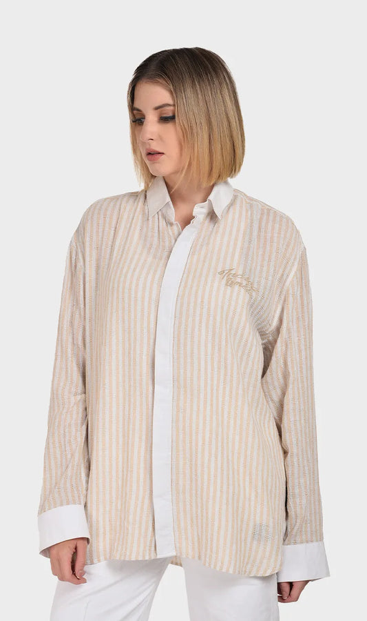 Front view of a women's beige and white striped long-sleeve shirt crafted from textured dobby fabric with contrasting white cuffs and collar.
