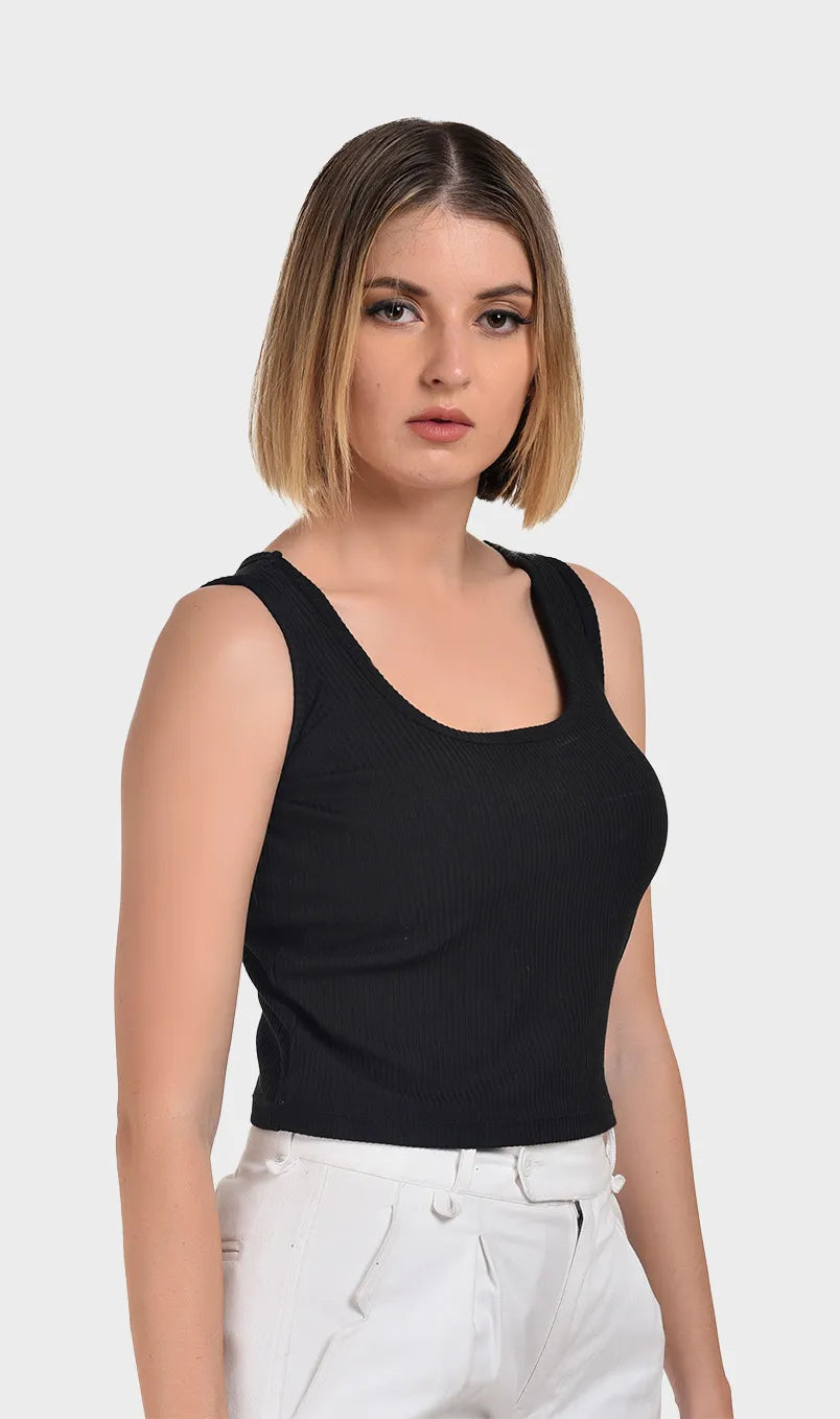 Three-quarter front profile of a female model wearing a black Parker fabric ribbed tank top.