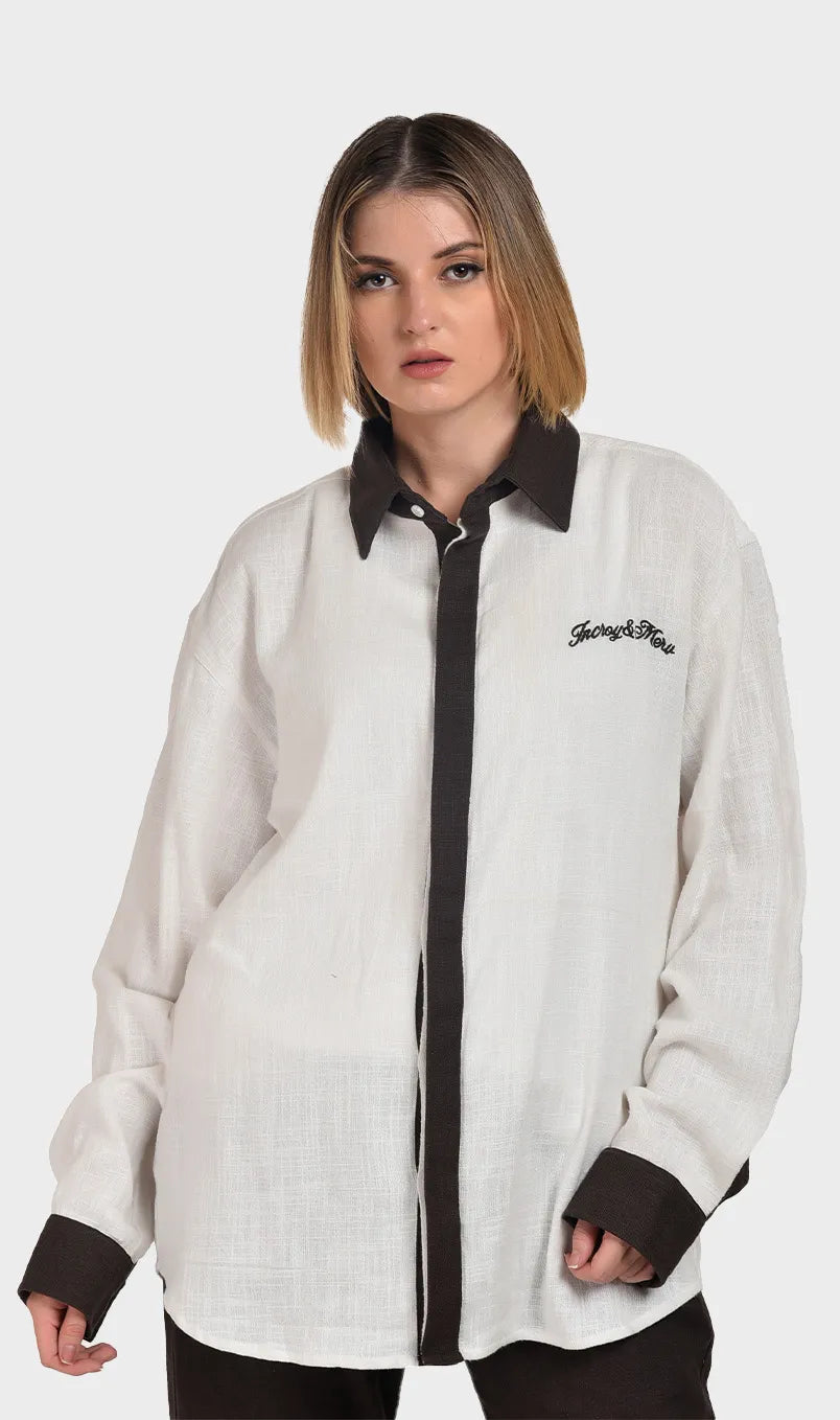 Front view of a women's off-white slub fabric shirt featuring a dark brown contrast collar, placket, and cuffs.