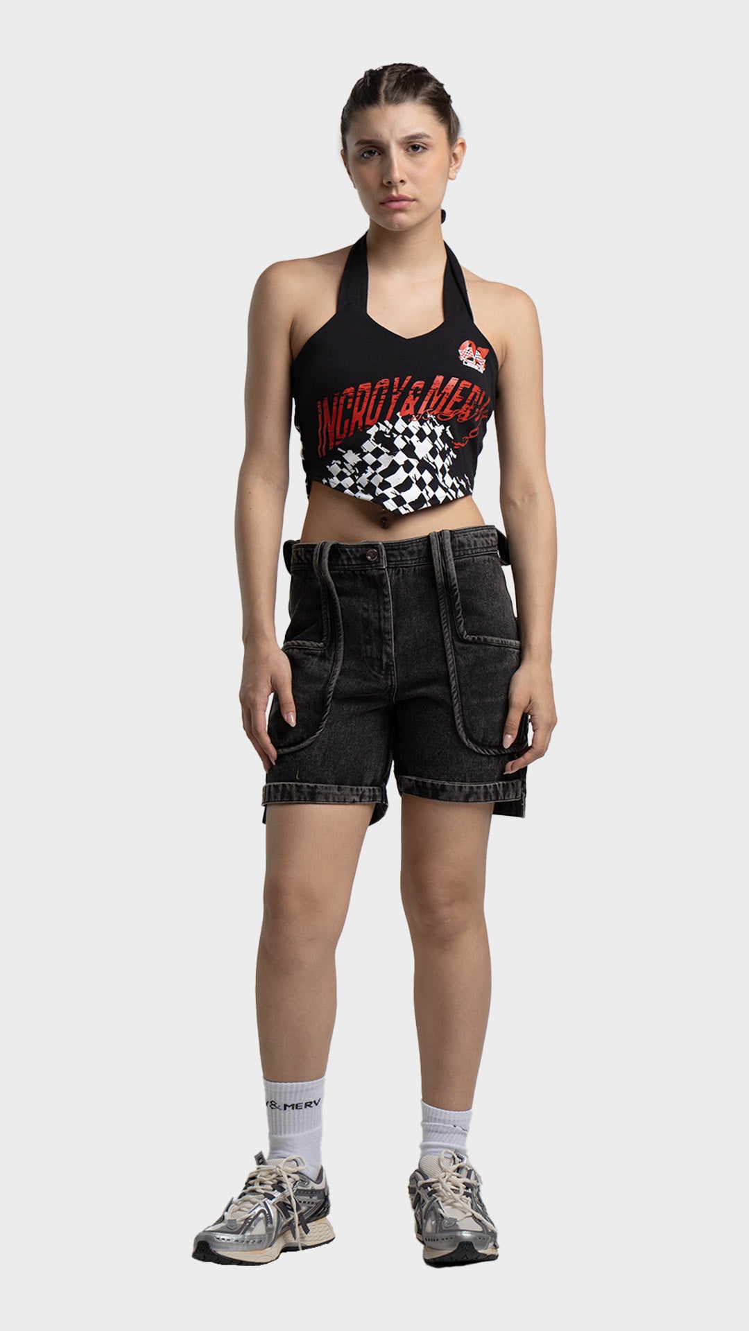 Full outfit look: checkered halter crop top with denim cargo shorts and sneakers.