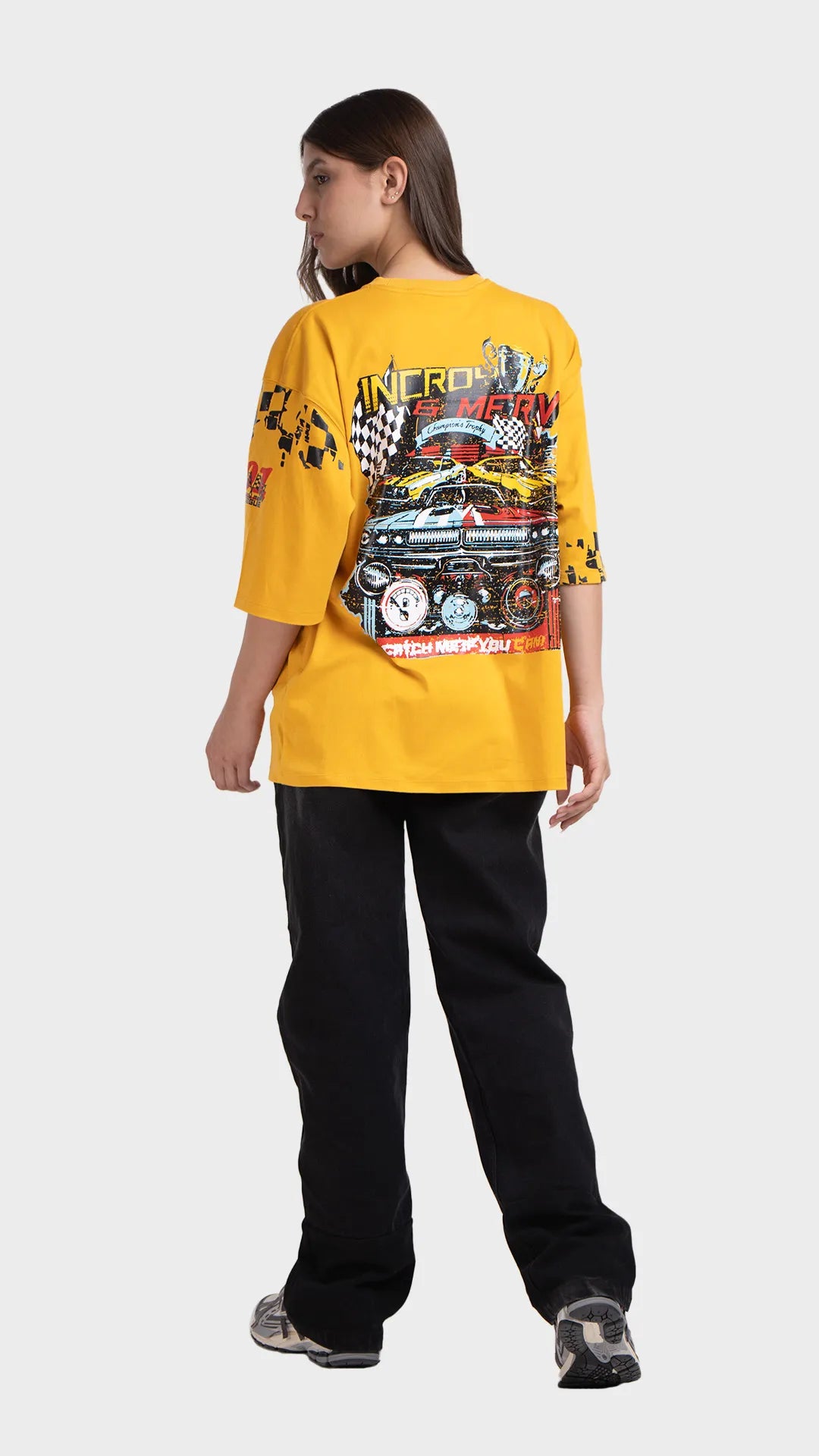 Oversized graphic t-shirt in yellow. Side view showing vintage racing graphic elements on the sleeves.